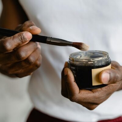 Person Holding Black and Silver Makeup Brush